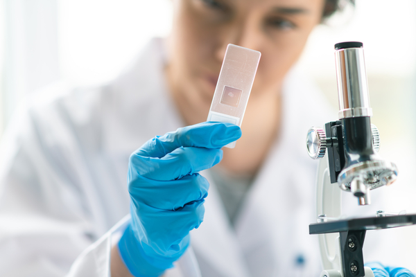 Doctor or nurse in a laboratory preparing a vaccine for a patient.