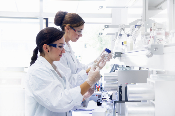 Doctor or nurse in a laboratory preparing a vaccine for a patient.