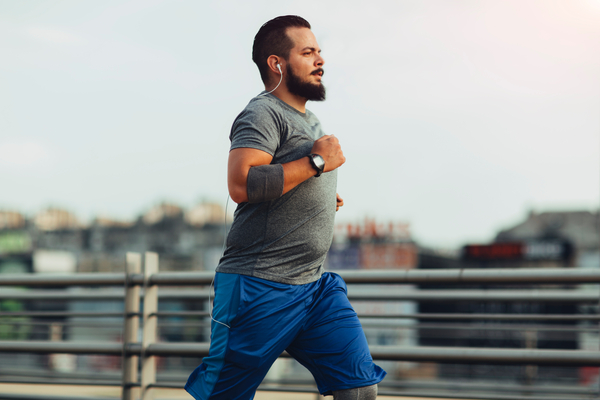 Man running in a street with headphones in ear